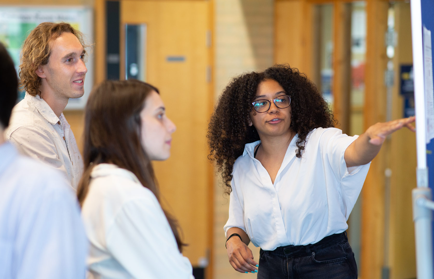 A photo of Freya Marijatta and Unit colleagues talking at summer Science Day 2022.
